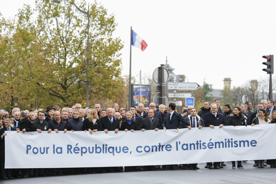 French Senate President Gerard Larcher seven left, President of the French National Assembly Yael Braun-Pivet sixth left, surrounded by French Prime Minister Elisabeth Borne, center, , France's former President Nicolas Sarkozy, fifth left, France's former President Francois Hollande Nine left and Chief Rabbi of France Haim Korsia, left, stand behind a banner which reads as "For The Republic, Against anti-Semistism" a demonstration against anti-Semitism in Paris, Sunday, Nov. 12, 2023. (Thomas Samson/Pool via AP)