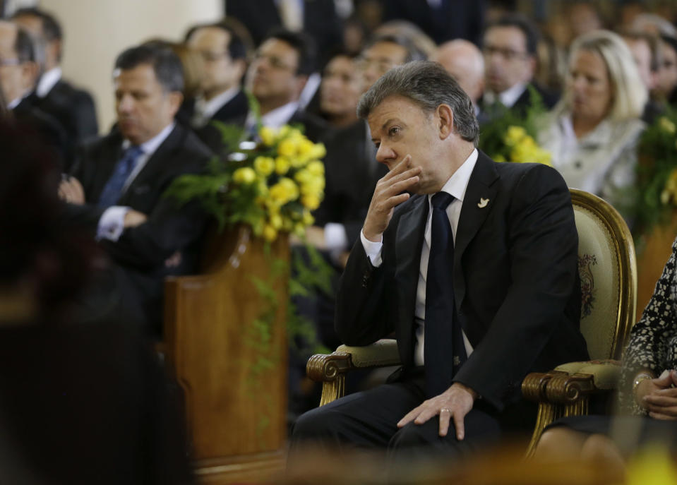 El presidente colombiano Juan Manuel Santos escucha el “Réquiem” de Mozart durante una ceremonia en honor al fallecido premio Nobel colombiano Gabriel García Márquez en la Catedral de Bogotá, Colombia, el martes 22 de abril de 2014. García Márquez, quien murió en la Ciudad de México el 17 de abril, es considerado uno de los más grandes escritores de la lengua española de todos los tiempos. (Foto AP/Fernando Vergara)