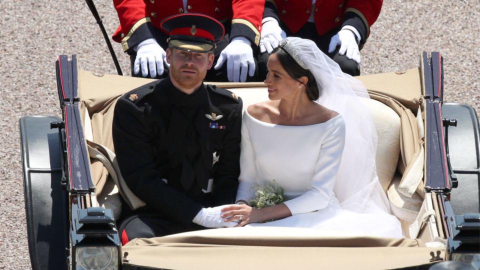 Prince Harry, Duke of Sussex and The Duchess of Sussex leave Windsor Castle in the Ascot Landau carriage during a procession after getting married at St Georges Chapel on May 19, 2018 in Windsor, England. (Photo by Yui Mok - WPA/Getty Images)