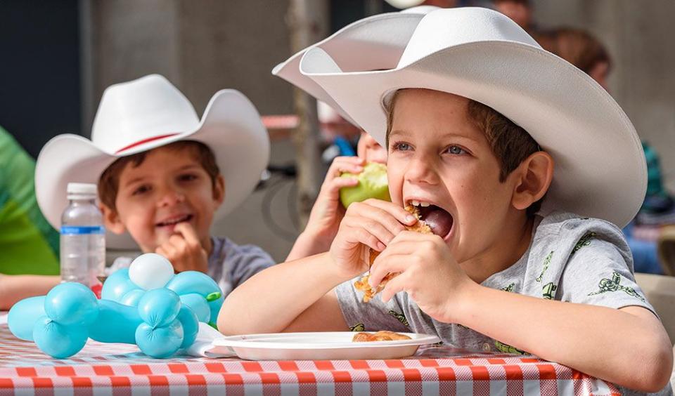  Luke, a six-year-old from Houston chows down on his Stampede breakfast on Thursday.