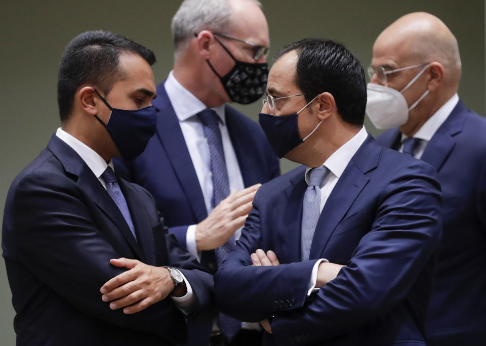 Cypriot Foreign Minister Nicos Christodoulides, second right, speaks with Italy's Foreign Minister Luigi Di Maio, left, during a meeting of EU foreign affairs ministers at the European Council building in Brussels, Monday, Sept. 21, 2020. European Union foreign ministers on Monday were weighing whether to impose sanctions on dozens of Belarus officials, including President Alexander Lukashenko, after holding talks with the country's exiled opposition leader. (Olivier Hoslet, Pool via AP)