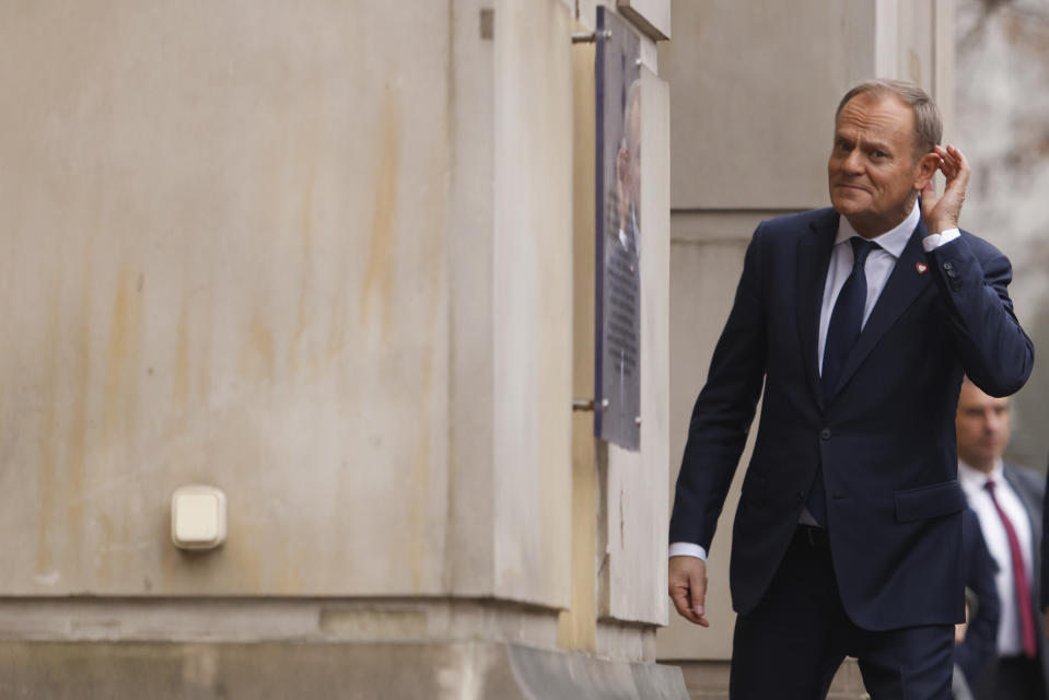 The new Polish Prime Minister Donald Tusk reacts to the journalists questions as he arrives at the Prime Minister's office in Warsaw, Poland, Wednesday, Dec. 13, 2023. (AP Photo/Michal Dyjuk)