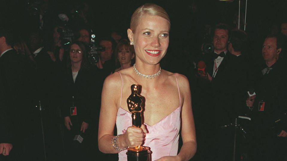 376971 03: 3/21/99 Los Angeles, CA. Gwyneth Paltrow holding her Oscar after winning Best Leading Actress at the Vanity Fair Oscar Party at Mortons Restaurant in West Hollywood.