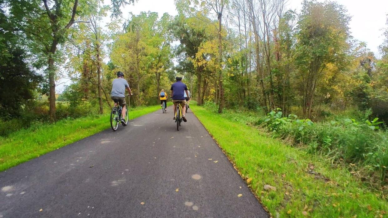 Cyclists ride the newly built section of the Pumpkinvine Nature Trail between county roads 35 and 20 in Middlebury, which opened in the last week of September 2023.