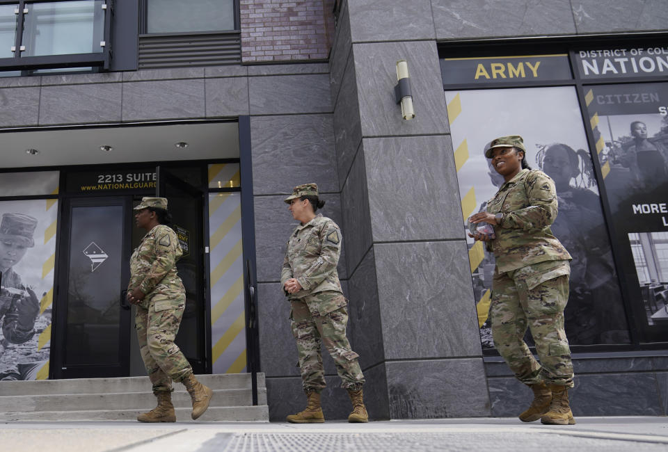 The U.S. Army National Guard members including recruitment chief Lt. Col. Amber Ellison, center, stand outside the Army National Guard office during training, Thursday, April 21, 2022 in Washington. In March the local guard opened its first proper recruiting office in the city since 2010. The commander, Maj. Gen. Sherrie McCandless, describes the move as a new push for visibility and an emphasis on the guard’s local connections at a time when many residents might be ripe for recruitment. (AP Photo/Mariam Zuhaib)