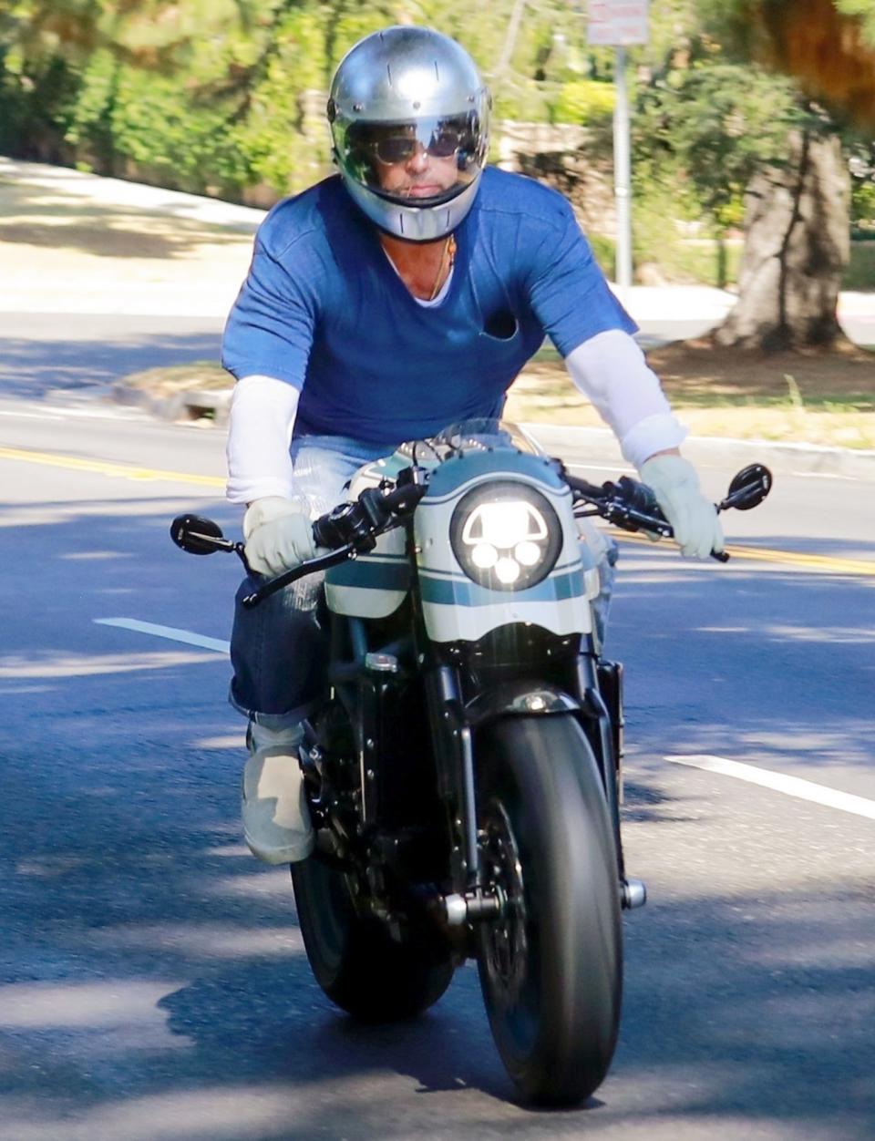 <p>Brad Pitt is seen leaving ex Angelina Jolie’s home on his motorcycle after a visit with their kids on Tuesday in Los Angeles. </p>