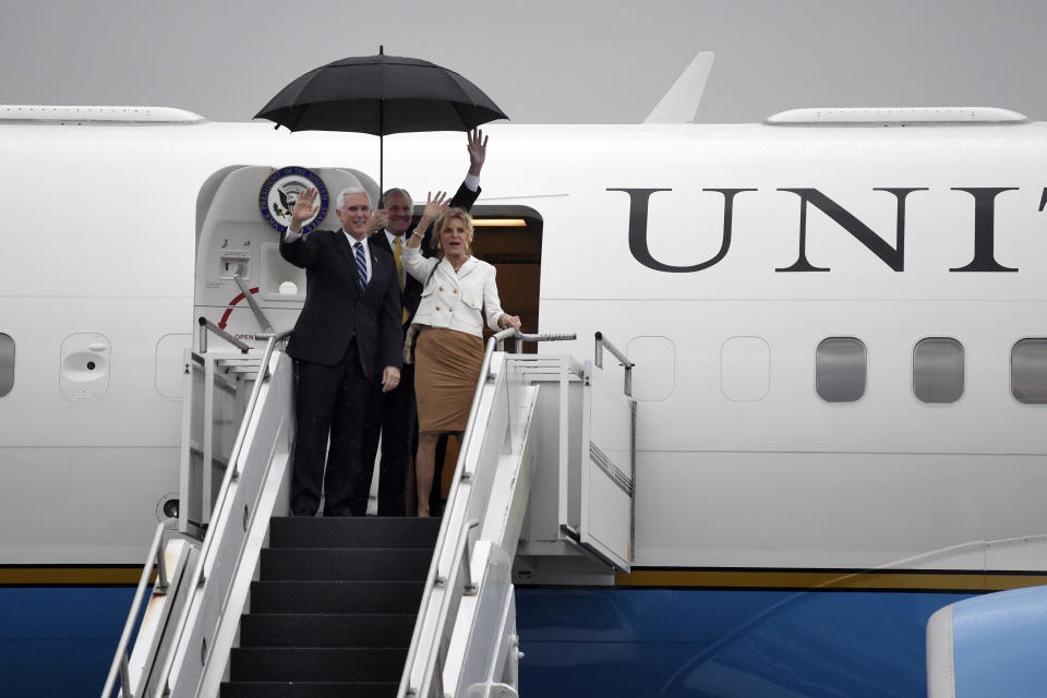 Vice President Mike Pence, left, arrives at Joint Base Charleston with South Carolina Gov. Henry McMaster, center, and his wife, Peggy, Thursday, Feb. 13, 2020, in North Charleston, S.C. (AP Photo/Meg Kinnard