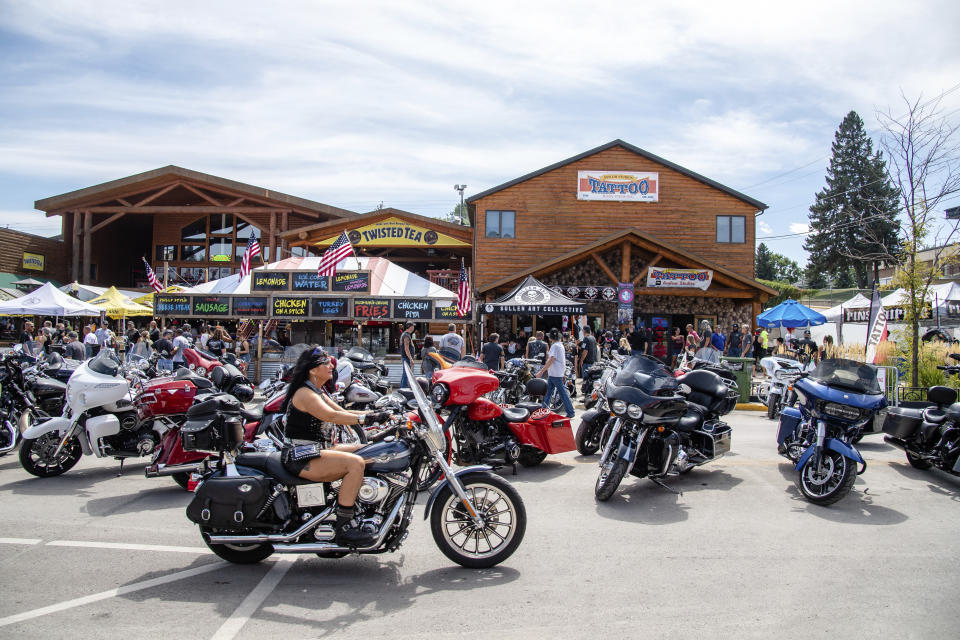 A biker rides down Main Street during the 80th annual Sturgis Motorcycle Rally on Saturday, Aug. 15, 2020, in Sturgis, S.D. (Amy Harris/Invision/AP)