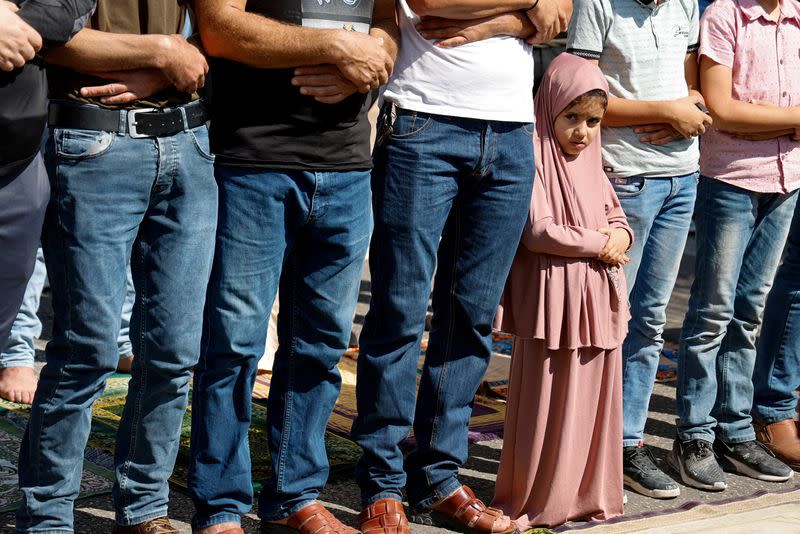 Palestinians take part in a protest following Israeli strikes on Gaza, in Nablus