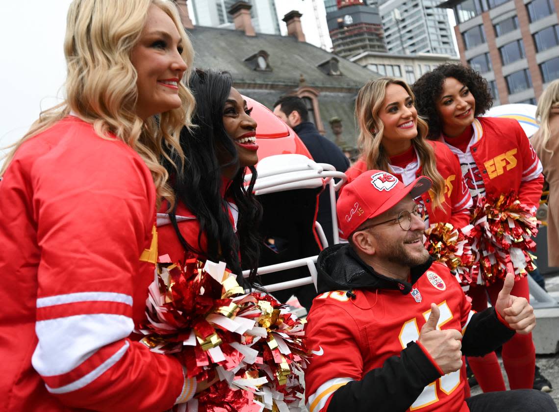 Ahead of Sunday’s Kansas City Chiefs-Miami Dolphins game, Goran (middle) from Frankfurt poses by an oversized helmet with the Kansas City Chiefs cheerleaders at the fan festival in the city center on Saturday, Nov. 4, 2023, in Frankfurt, Germany. picture alliance/dpa/picture-alliance/Sipa USA