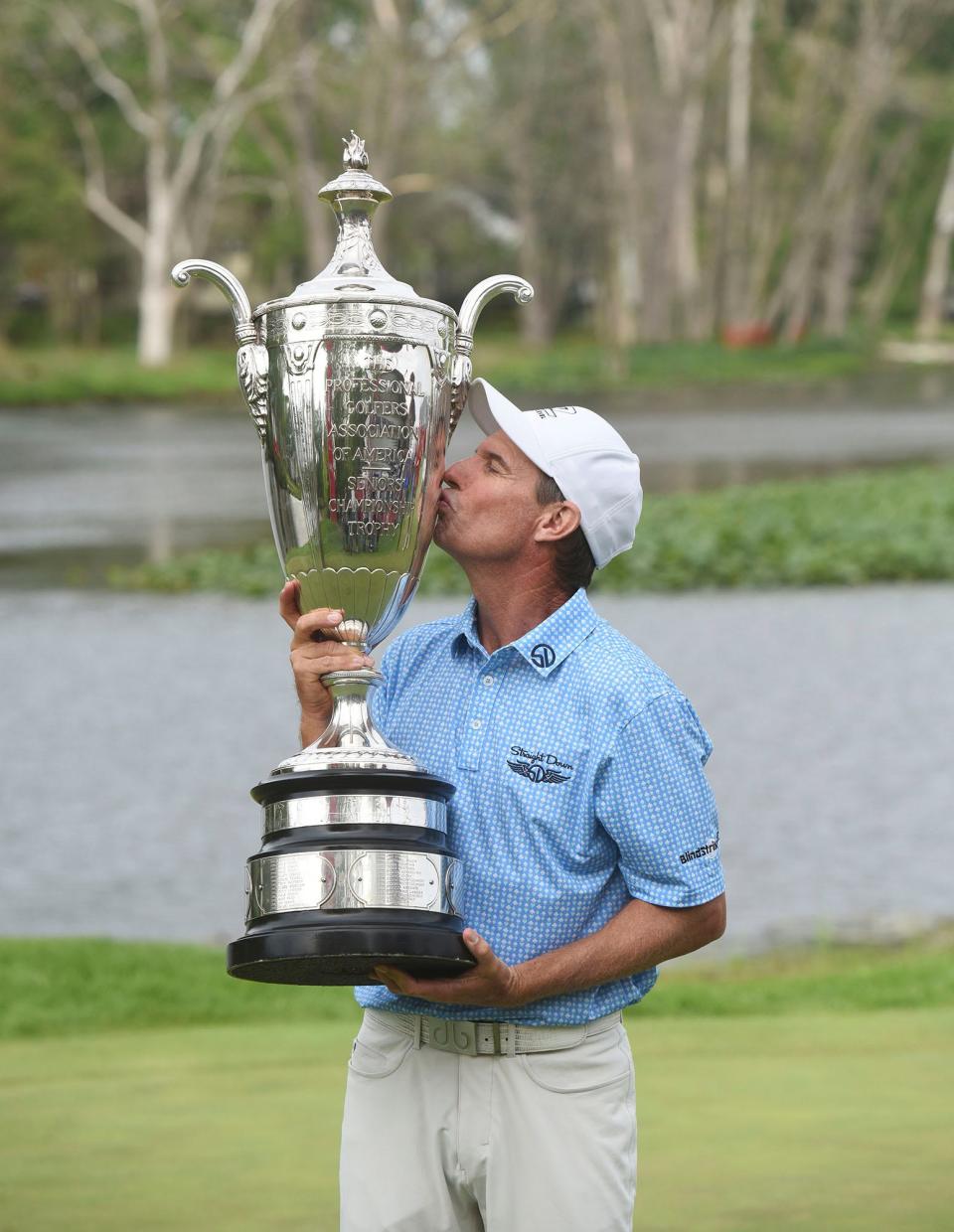 Steven Alker kisses the Alfred S. Bourne Trophy, Sunday, May 29, 2022, after winning the Senior PGA Championship golf tournament at Harbor Shores in Benton Harbor, Mich. (Don Campbell/The Herald-Palladium via AP)