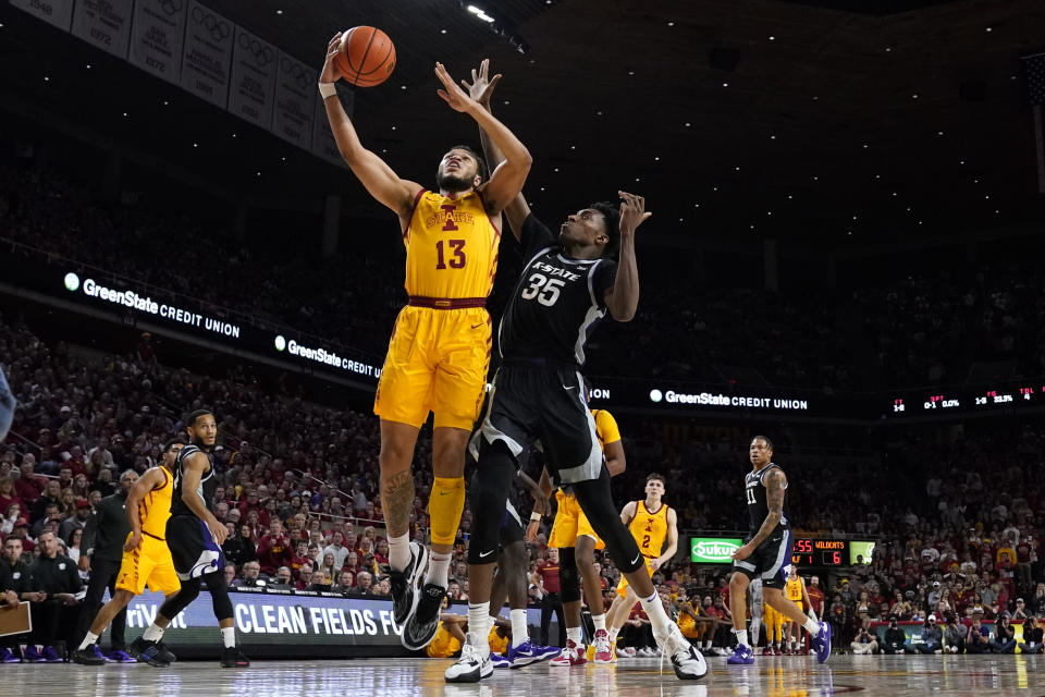 Iowa State guard Jaren Holmes (13) drives to the basket past Kansas State forward Nae'Qwan Tomlin (35) during the first half of an NCAA college basketball game, Tuesday, Jan. 24, 2023, in Ames, Iowa. (AP Photo/Charlie Neibergall)