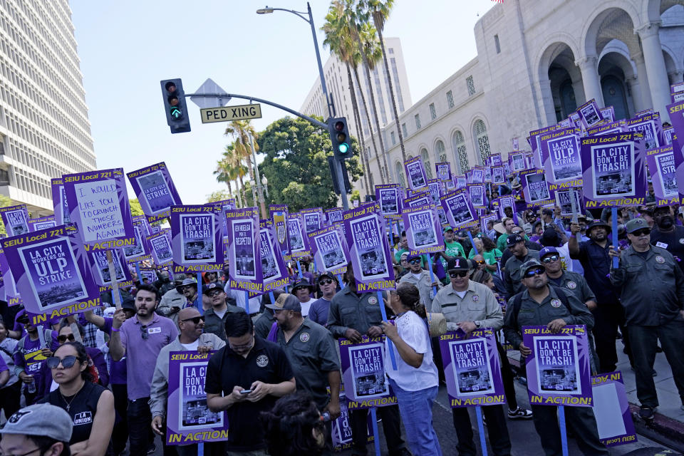 Workers picket outside of City Hall Tuesday, Aug. 8, 2023, in Los Angeles. Thousands of Los Angeles city employees, including sanitation workers, engineers and traffic officers, walked off the job for a 24-hour strike alleging unfair labor practices. The union said its members voted to authorize the walkout because the city has failed to bargain in good faith and also engaged in labor practices that restricted employee and union rights. (AP Photo/Ryan Sun)