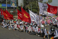 Medical students display flags of the National League for Democracy party during an anti-coup demonstration in Mandalay, Myanmar, Thursday, March 4, 2021. Demonstrators in Myanmar protesting last month's military coup returned to the streets Thursday, undaunted by the killing of at least 38 people the previous day by security forces. (AP Photo)