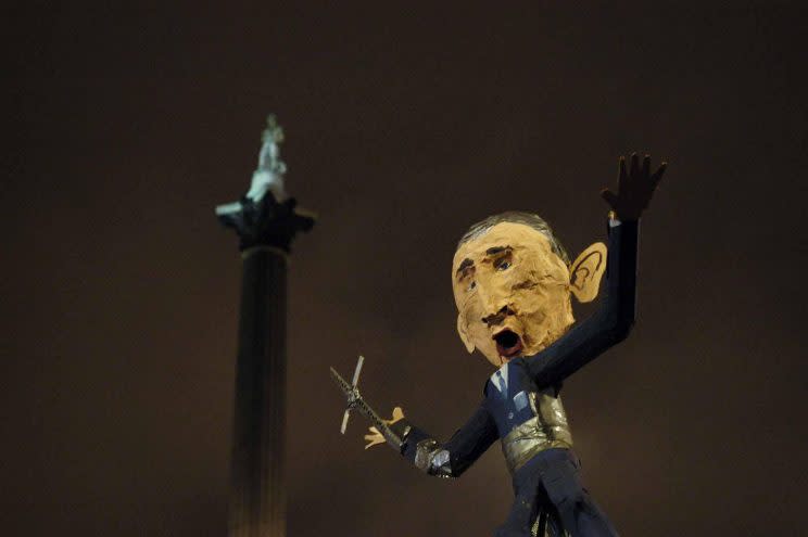 An effigy is waved during the Anti-Bush protest march in Trafalgar Square, London (PA)