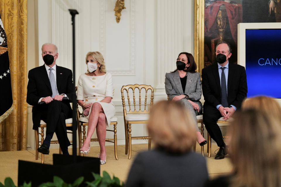 U.S. President Joe Biden, First Lady Jill Biden, Vice President Kamala Harris, and Second Gentleman Doug Emhoff, sit on stage at an event to reignite the 'Cancer Moonshot' initiative with a goal to reduce cancer death by 50 percent over the next 25 years, in the East Room at the White House in Washington, D.C., U.S., February 2, 2022. REUTERS/Cheriss May