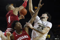 Indiana forwards Trayce Jackson-Davis (4) and De'Ron Davis and Michigan forward Brandon Johns Jr. (23) loose control of a rebound during the second half of an NCAA college basketball game Sunday, Feb. 16, 2020, in Ann Arbor, Mich. (AP Photo/Carlos Osorio)