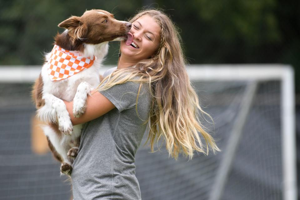 Tennessee Lady Vols soccer fifth year forward Mackenzie George gets a kiss from her dog Rocky at soccer media day at Regal Stadium in Knoxville, Tenn. on Thursday, Aug. 11, 2022.