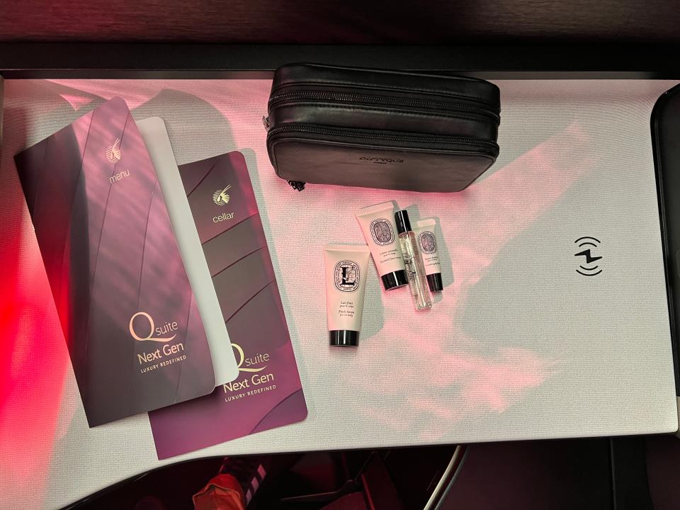 Diptyque amenities, pamphlets, and a wireless charging port in QSuite Next Gen at the 2024 Farnborough Airshow