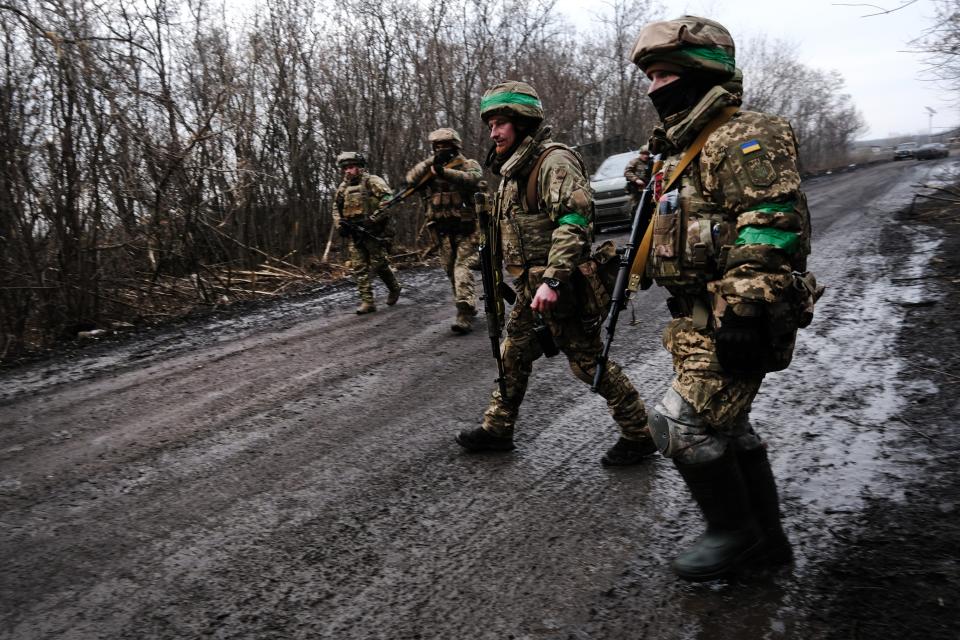 Ukrainian soldiers walk along a road outside of the strategic city of Bakhmut (Getty)