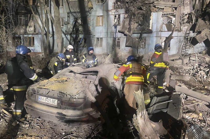 Emergency workers comb the site of a damaged residential building in Zaporizhzhia, Ukraine, on March 2 after a Russian rocket hit the five-story building. File Photo courtesy of State Emergency Service of Ukraine/EPA-EFE