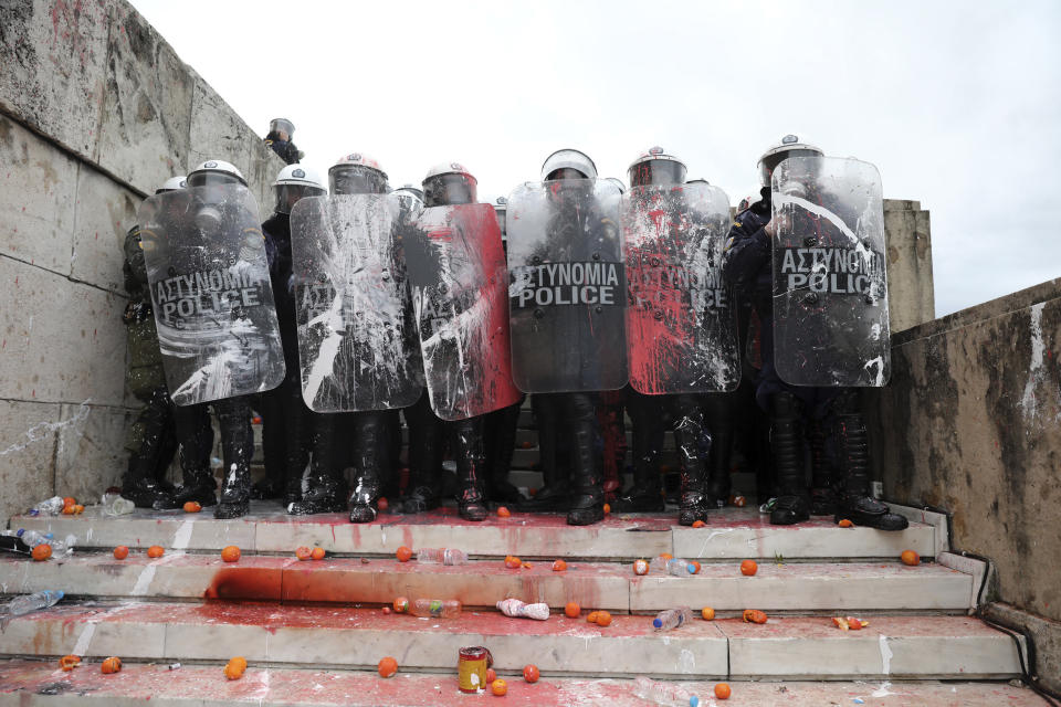 Greek riot police block the stairs leading to parliament during clashes after a rally in Athens, Sunday, Jan. 20, 2019. Greece's Parliament is to vote this coming week on whether to ratify the agreement that will rename its northern neighbor North Macedonia. Macedonia has already ratified the deal, which, polls show, is opposed by a majority of Greeks. (AP Photo/Yorgos Karahalis)