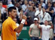 Novak Djokovic of Serbia reacts after defeating Rafael Nadal of Spain during their semi-final match at the Monte Carlo Masters in Monaco April 18, 2015. REUTERS/Jean-Paul Pelissier