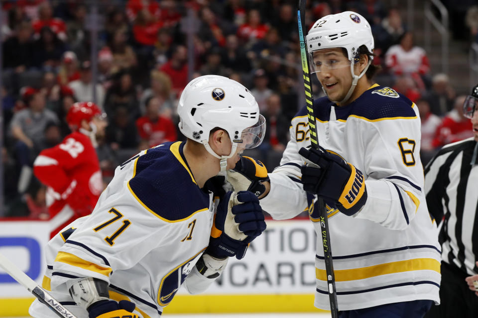 Buffalo Sabres left wing Evan Rodrigues (71) celebrates his goal with Brandon Montour in the first period of an NHL hockey game against the Detroit Red Wings, Sunday, Jan. 12, 2020, in Detroit. (AP Photo/Paul Sancya)