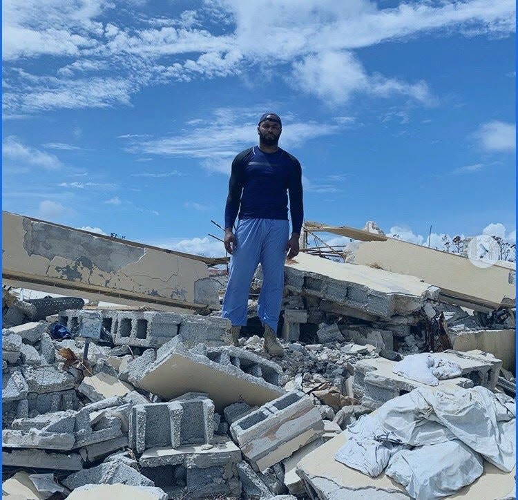 Myron Rolle stands on what was the health clinic in High Rock, Bahamas