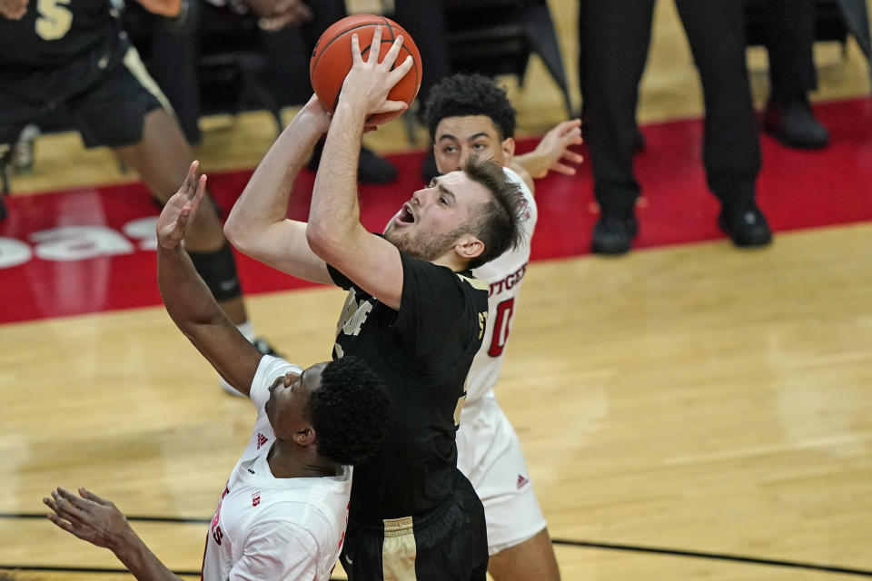 Rutgers guard Geo Baker (0) defends against Purdue guard Sasha Stefanovic (55), who goes up for a shot during the first half of an NCAA college basketball game Tuesday, Dec. 29, 2020, in Piscataway, N.J.. (AP Photo/Kathy Willens)