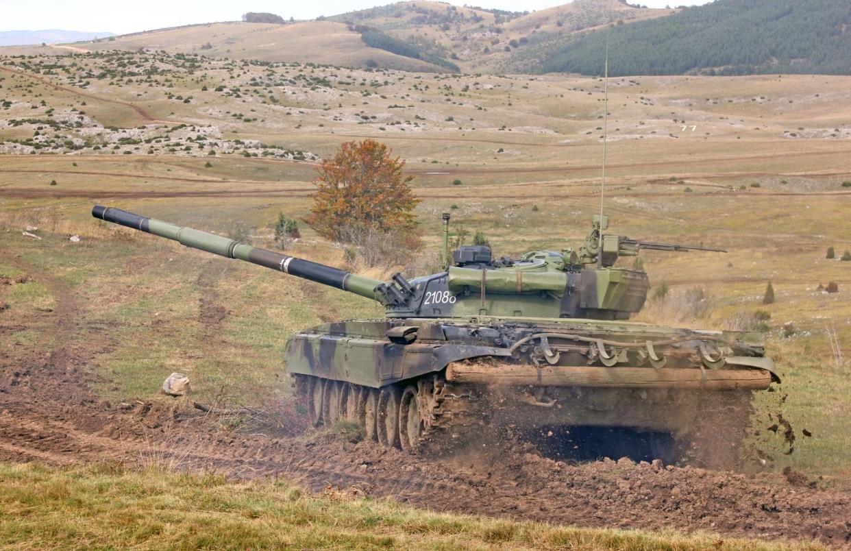 a group of military tanks in a field