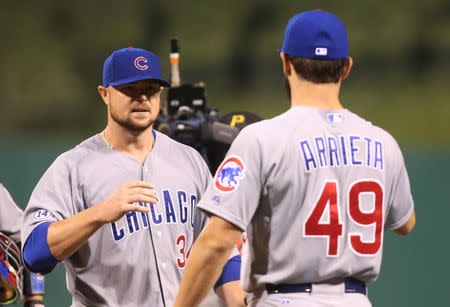 Sep 15, 2015; Pittsburgh, PA, USA; Chicago Cubs starting pitcher Jon Lester (34) celebrates with pitcher Jake Arrieta (49) after a complete game against the Pittsburgh Pirates at PNC Park. Mandatory Credit: Charles LeClaire-USA TODAY Sports