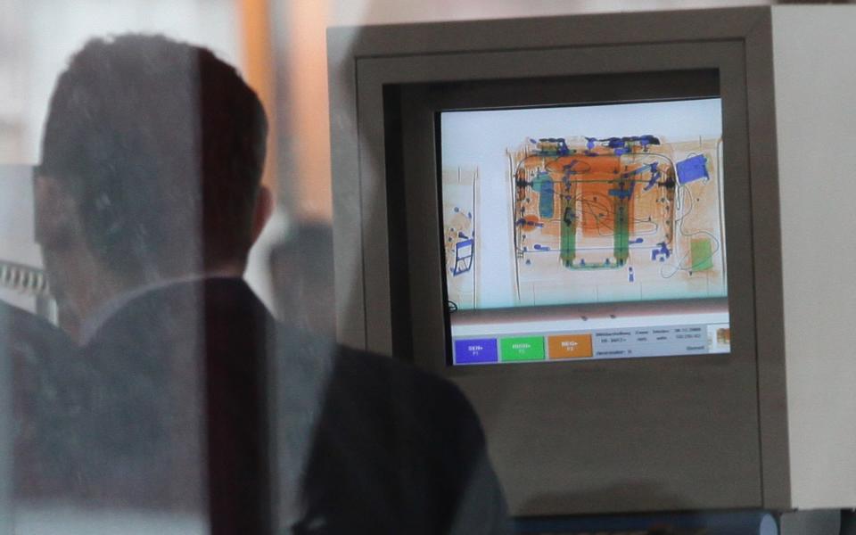 An x-ray machine shows a passenger's hand baggage at a security check