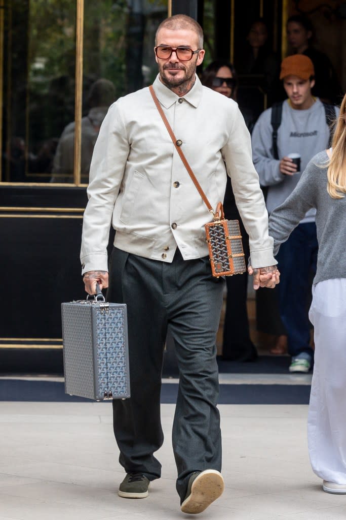 David Beckham, fashion-forward as always, sported not one, but two trendy bags. GC Images