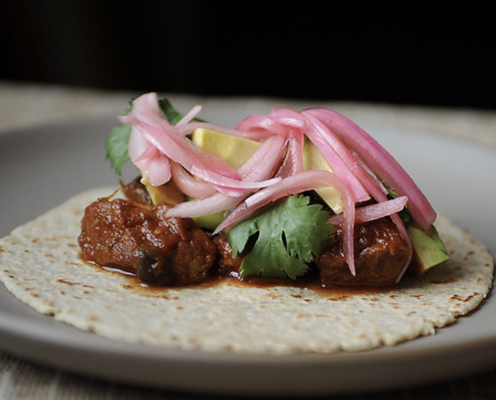 Tender pork + homemade pickled onions = true love. Recipe: Slow Cooked Pork Tacos