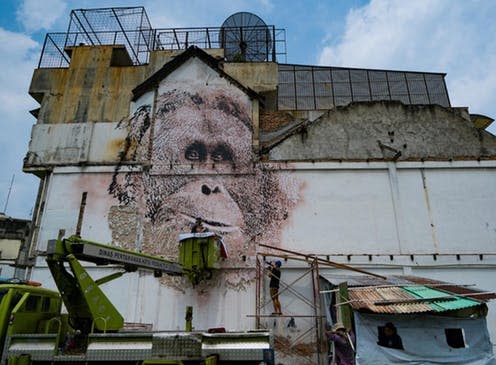 <span class="caption">'Vhils', a Portuguese street artist, chisels an endangered orangutan onto a wall in the city of Medan, Indonesia.</span> <span class="attribution"><a class="link " href="https://www.instagram.com/p/BhjRXqKFdaw/" rel="nofollow noopener" target="_blank" data-ylk="slk:splashandburn / instagram;elm:context_link;itc:0;sec:content-canvas">splashandburn / instagram</a></span>