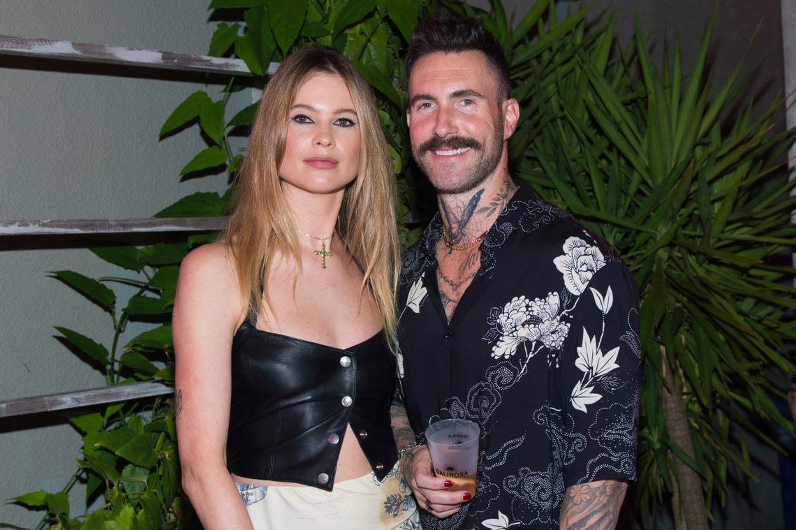 Behati Prinsloo, left, and Adam Levine attend Calirosa Tequila Sunset Happy Hour during the South Beach Wine and Food Festival on Thursday, Feb. 24, 2022, in Miami Beach. (Photo by Scott Roth/Invision/AP)