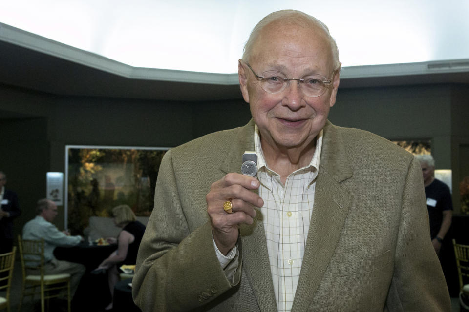 Dr. Richard Moriarty, creator of Mr. Yuk, shows his Mr. Yuk money clip at Carnegie Museum of Natural History, Botany Hall, Thursday, June 1, 2023, in Oakland, Pa. Moriarty passed away on Thursday, Sept. 7, according to Jeffrey Fugh of the funeral home John A. Freyvogel Sons Inc., which is handling arrangements in Pittsburgh. (John Colombo /Pittsburgh Post-Gazette via AP)