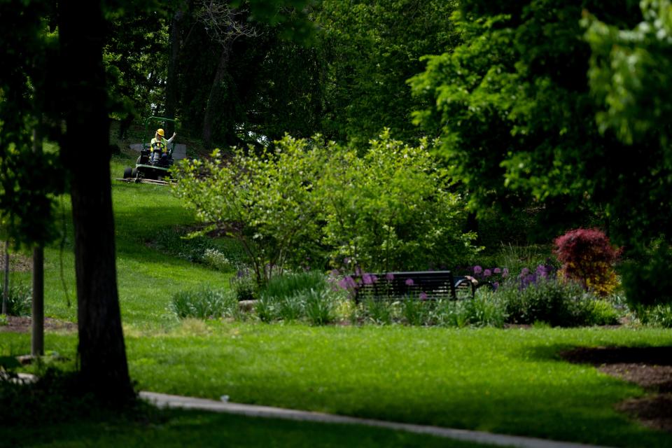 A Cincinnati Parks employee mows at Eden Park in Cincinnati on Thursday, May 11, 2023. 