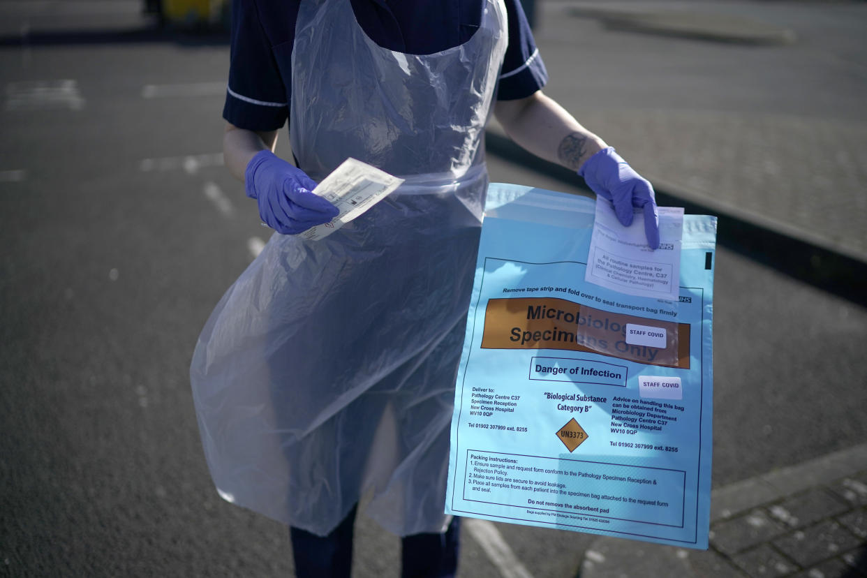 WOLVERHAMPTON, ENGLAND - APRIL 07: A nurse poses with a testing kit as National Health Service (NHS) workers are tested for Coronavirus (Covid-19) at a drive through testing site on April 07, 2020 in Wolverhampton, England. There have been around 50,000 reported cases of the COVID-19 coronavirus in the United Kingdom and over 5,000 deaths. The country is in its third week of lockdown measures aimed at slowing the spread of the virus. (Photo by Christopher Furlong/Getty Images)