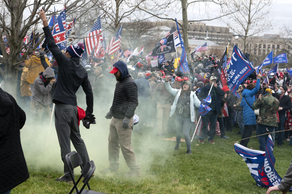 FILE - In this Jan. 6, 2021, file photo, supporter of President Donald Trump protest as U.S. Capitol Police officers shoot tear gas at demonstrators outside of the U.S. Capitol in Washington. Far-right social media users for weeks openly hinted in widely shared posts that chaos would erupt at the U.S. Capitol while Congress convened to certify the election results. (AP Photo/Jose Luis Magana)