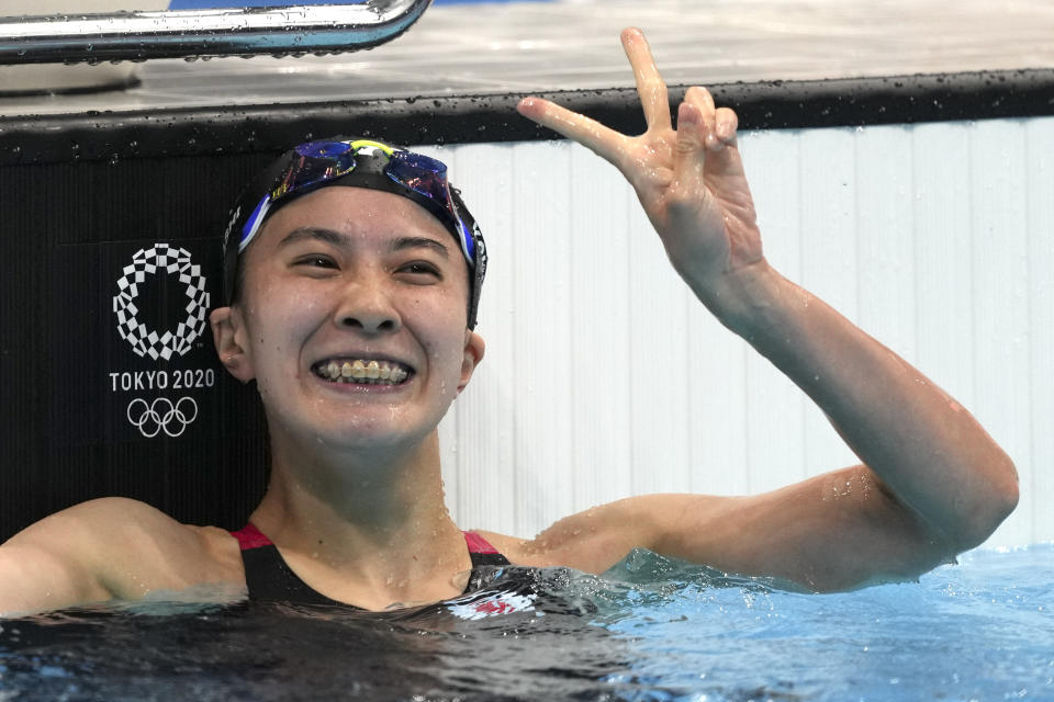 Yui Ohashi of Japan waves after winning the women's 200-meter individual medley final at the 2020 Summer Olympics, Wednesday, July 28, 2021, in Tokyo, Japan. (AP Photo/Matthias Schrader)