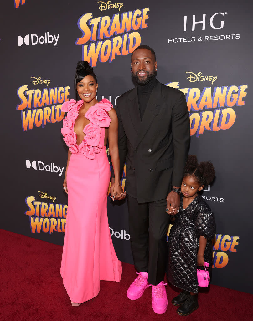 LOS ANGELES, CALIFORNIA - NOVEMBER 15: (L-R) Gabrielle Union, Dwyane Wade, and Kaavia James Union Wade attend the world premiere of Walt Disney Animation Studios'  Strange World at El Capitan Theatre in Hollywood, California on November 15, 2022. (Photo by Jesse Grant/Getty Images for Disney)