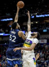 Minnesota Timberwolves center Karl-Anthony Towns (32) shoots over New Orleans Pelicans forward Anthony Davis (23) during the first half of an NBA basketball game in New Orleans, Friday, Feb. 8, 2019. (AP Photo/Scott Threlkeld)