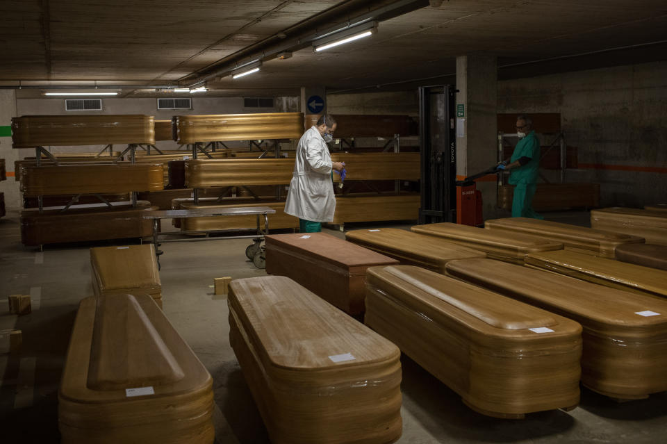 Coffins with the bodies of victims of coronavirus are stored waiting for burial or cremation at the Collserola morgue in Barcelona, Spain, Thursday, April 2, 2020. The new coronavirus causes mild or moderate symptoms for most people, but for some, especially older adults and people with existing health problems, it can cause more severe illness or death. (AP Photo/Emilio Morenatti)