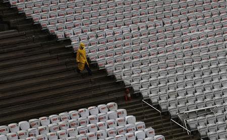 A labourer works on the construction site of the Arena de Sao Paulo Stadium, which will host the opening soccer match of the 2014 FIFA World Cup, in Sao Paulo April 15, 2014. REUTERS/Nacho Doce