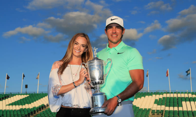 Brooks Koepka holding a trophy.