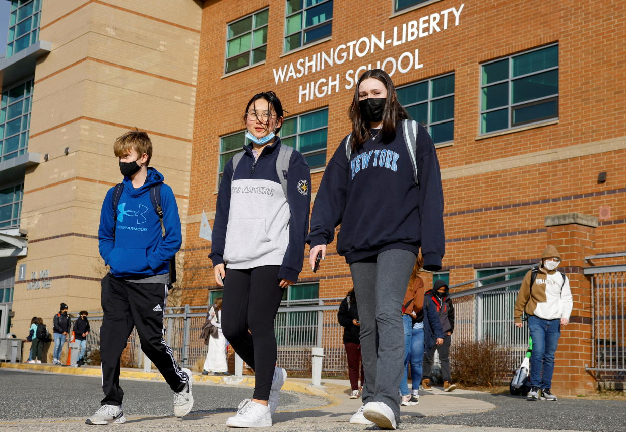 Students leave Washington-Liberty High School in Arlington County which is one of several school districts which sued to stop the mask-optional order by Governor Glenn Youngkin (R), in Arlington, Virginia, U.S., January 25, 2022. REUTERS/Evelyn Hockstein