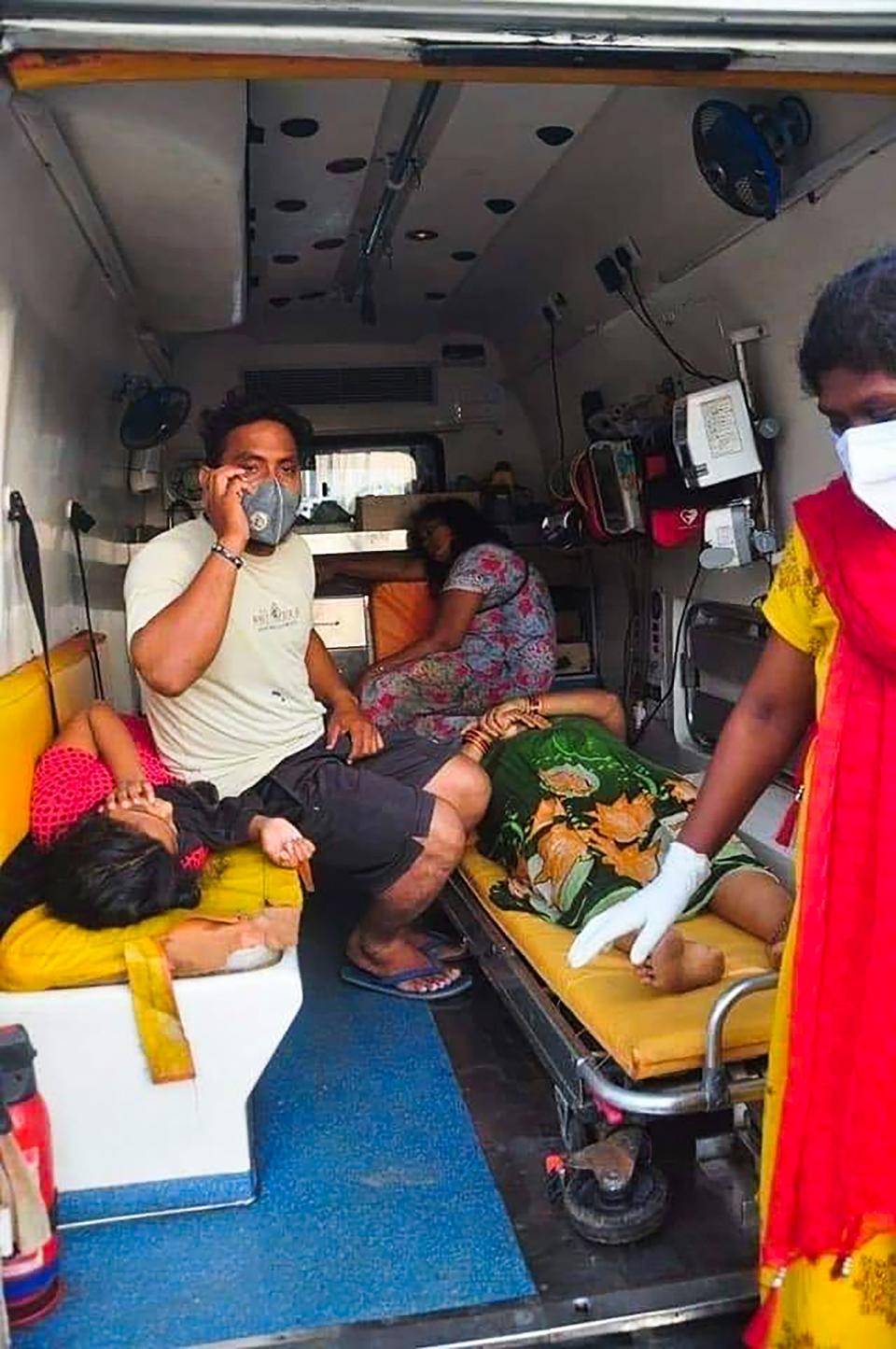 Women are evacuated to a hospital in an ambulance following a gas leak incident from an LG Polymers plant in Visakhapatnam on May 7, 2020. - At least five people have been killed and 1,000 hospitalised after a gas leak at a chemicals plant on the east coast of India, authorities said on May 7, warning the death toll would climb. The gas leaked out of two 5,000-tonne tanks that had been unattended due to India's coronavirus lockdown in place since late March, according to a local police officer. (Photo by - / AFP) (Photo by -/AFP via Getty Images)