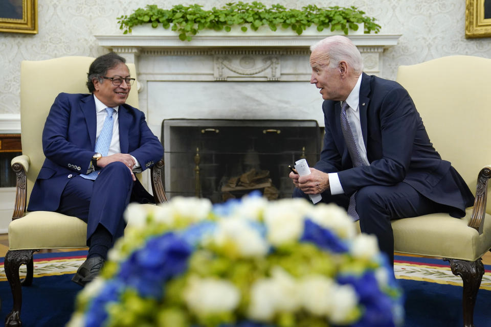 President Joe Biden leans over to speak with Colombian President Gustavo Petro as reporters yell questions after they gave statements in the Oval Office of the White House in Washington, Thursday, April 20, 2023. (AP Photo/Susan Walsh)